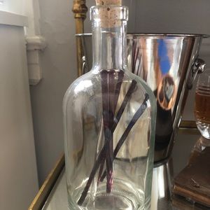 Corked glass bottle with cocktail stirrers